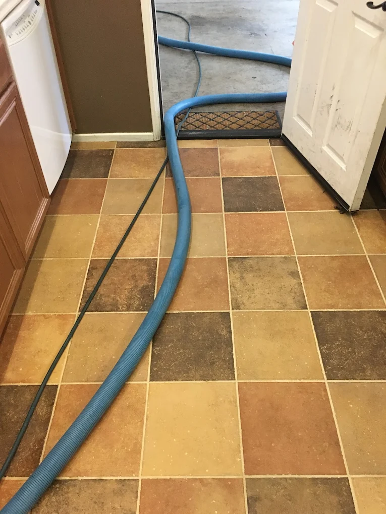 Tile and grout restoration mid-job in a kitchen entry